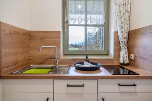 a kitchen with a sink and a window at Fewo Brünnstein - Nr 40 Pool, Sauna in Oberaudorf