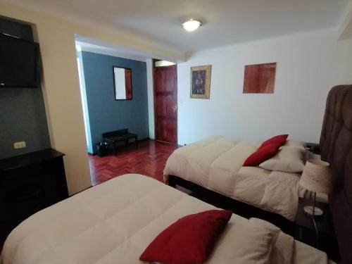 a hotel room with two beds in a room at Hotel Juan in Arequipa