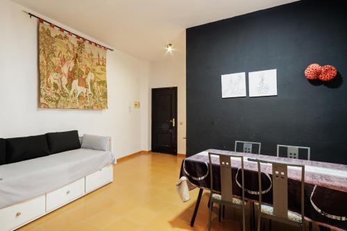 a living room with a bed and a black wall at Conde Center Premium Suites in Seville