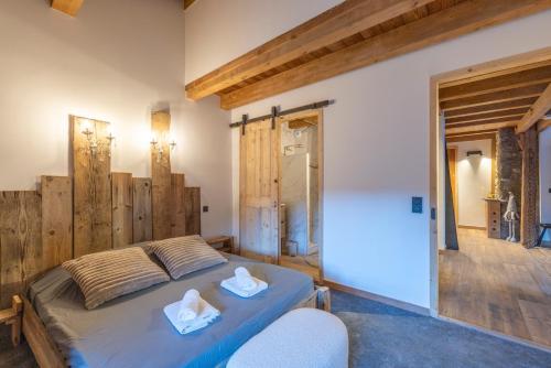 a bedroom with a bed with two towels on it at Albert le Cerf in Morillon