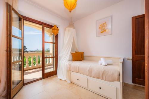 a bedroom with a bed and a large window at Oasis del Sol in Llombarts