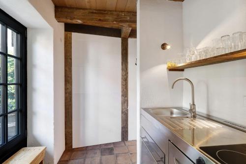 a kitchen with a sink and a window at Loft Im Künstlerhaus in Riegel am Kaiserstuhl