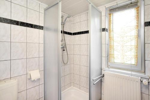 a bathroom with a shower and a toilet and a window at Ferienhaus Pahnke in Bergen auf Rügen