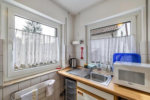 a small kitchen with a sink and a window at Ferienwohnung Behrens-Reinke in Albstadt