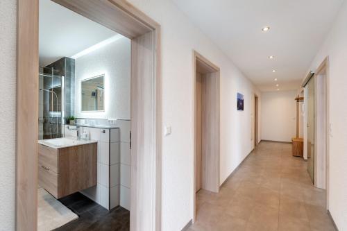a bathroom with a sink and a mirror at Ferienwohnung Käshammer in Kappelrodeck