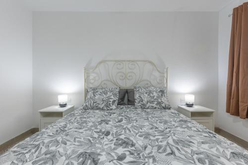 a bedroom with a large bed with two night stands at Edificio El Baifo Loco - Constantin in Gran Tarajal