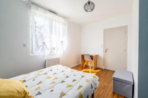 a bedroom with a bed and a window and a desk at Maison Ker Morin La Gacilly in La Gacilly