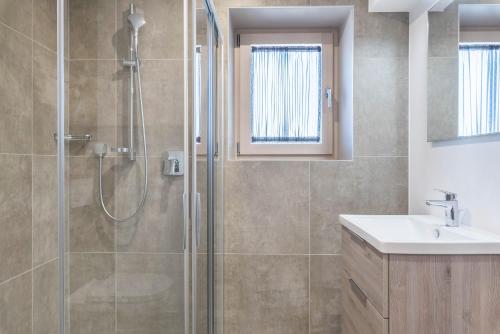 a bathroom with a shower and a sink at Aster Moments Apt Marie in San Genesio Atesino