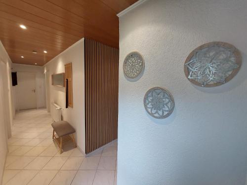 a hallway with three decorative plates on the wall at Ferienhaus Dorfidylle in Oberzent