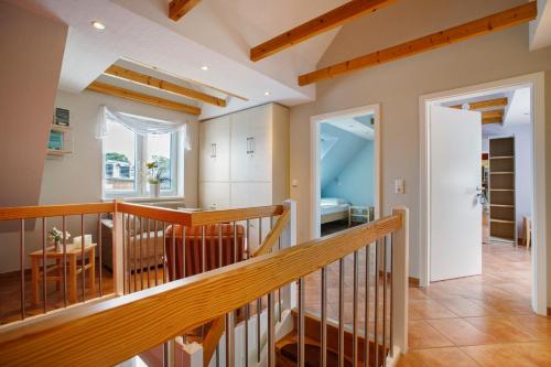 a staircase in a house with a hallway and a room at Ferienhaus Siegfried in Niebüll