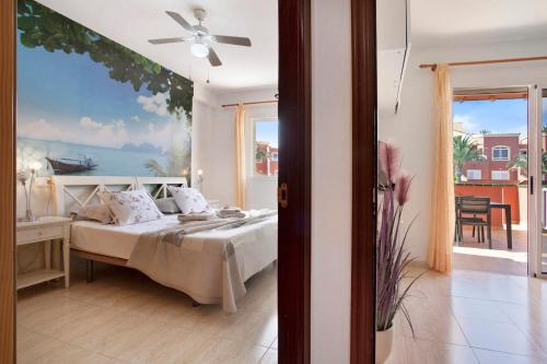 a bedroom with a bed with a painting on the wall at Little Dunes in Corralejo