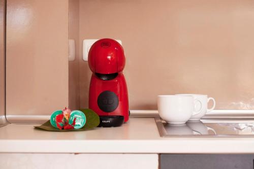 a red coffee maker and a cup on a counter at Little Dunes in Corralejo