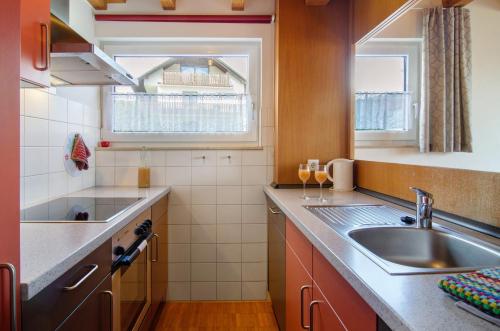 a small kitchen with a sink and a window at Merk Ferienwohnungen Gbr in Bodman-Ludwigshafen