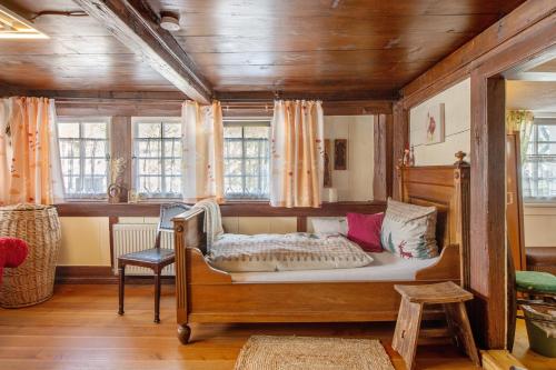 a bedroom with a bed in a room with windows at Schwarzwaldcasa in Todtmoos