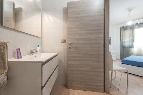 a bathroom with a sink and a shower backdoor at Casa Vacanza Casi 1 in Villasimius