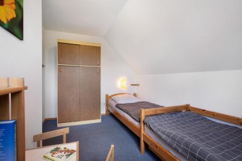 a bedroom with a bed and a cabinet in it at Ferienwohnung Nico in Langballig