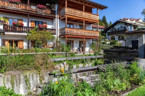 a building with balconies and flowers in front of it at Chalet Falkenstein in Garmisch-Partenkirchen