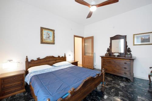 a bedroom with a bed and a ceiling fan at Il Porto in Celle Ligure