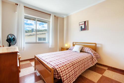a bedroom with a bed and a window at La bodegueta in Orba