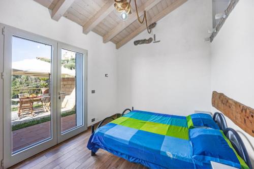 a bedroom with a bed and a balcony at Pelagos in Pompeiana