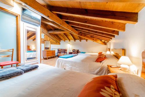a bedroom with two beds and a large window at Amontes Rural in Nestar