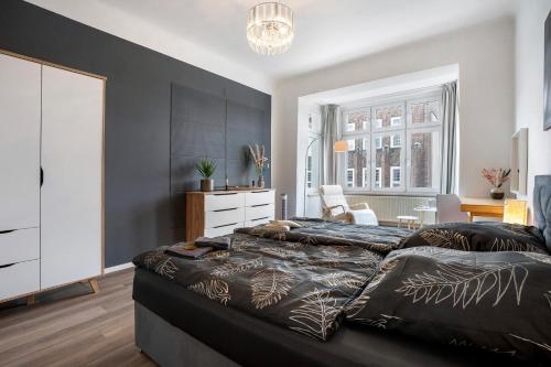a bedroom with two beds and a dresser in it at Ferienwohnung Chemnitz City in Chemnitz