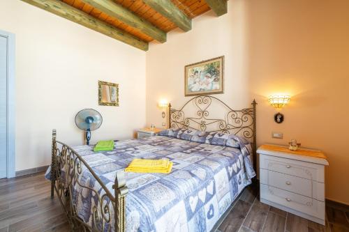 a bedroom with a bed with a blue and white bedspread at Da Giò, a due passi dal mare in Calasetta