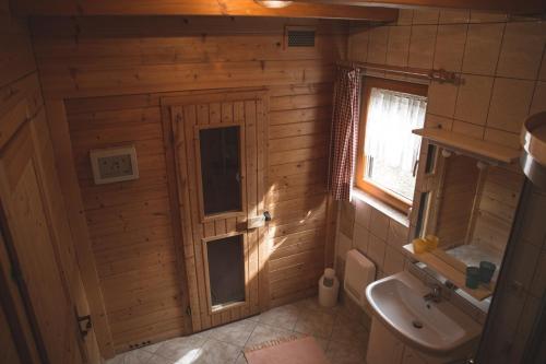 a bathroom with a sink and a toilet and a window at Ferienhaus Klippitzblick in Klippitztorl