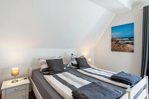 two beds in a bedroom with white walls at Sonnenhaus am See in Schwerin