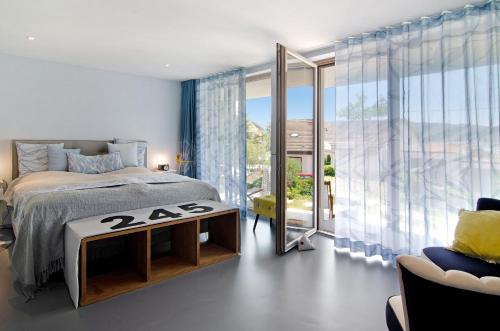 a bedroom with a bed and a large window at Seeart-apartment No 86 in Ludwigshafen