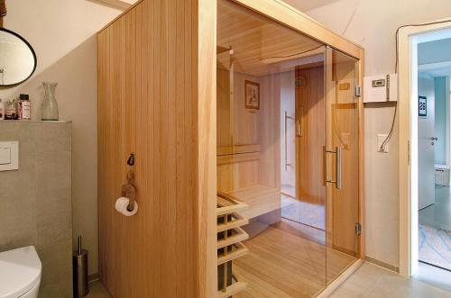 a bathroom with a walk in closet with a glass door at Seeart-apartment No 86 in Ludwigshafen