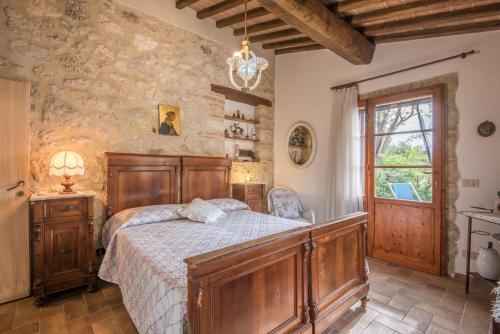 a bedroom with a bed in a room with a stone wall at Appartamento Capannina in Lucciana