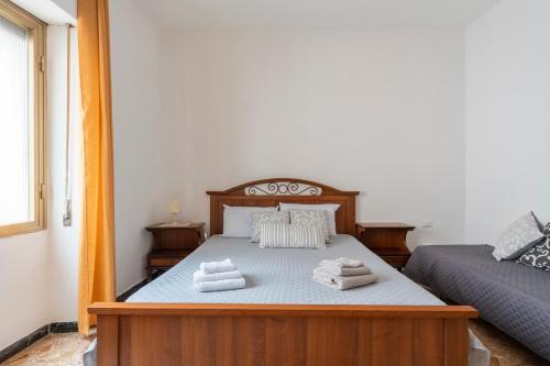 a bedroom with a bed with towels on it at Jerzu Centro 2 in Jerzu