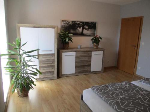 a room with a bedroom with a bed and a mirror at Fewo 1 - Osterberg in Liebenau