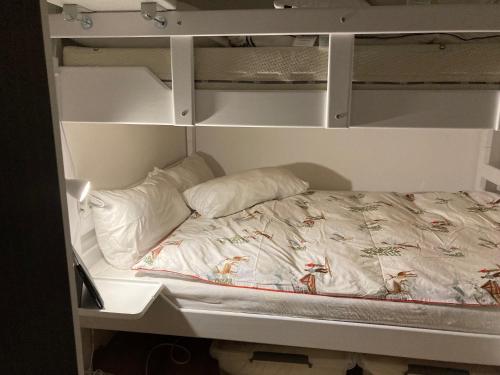 an empty bunk bed with two pillows on it at Somski Saalbach in Saalbach-Hinterglemm
