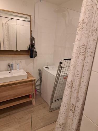 a bathroom with a sink and a shower curtain at Somski Saalbach in Saalbach-Hinterglemm