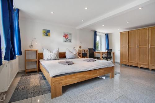 a bedroom with a large bed with blue curtains at Bäckerhus - Ferienwohnung 1 in Wiek auf Rügen