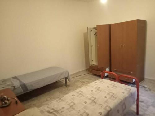 a hospital room with a bed and a cabinet at Casa Azzurra 56 in Bova Marina