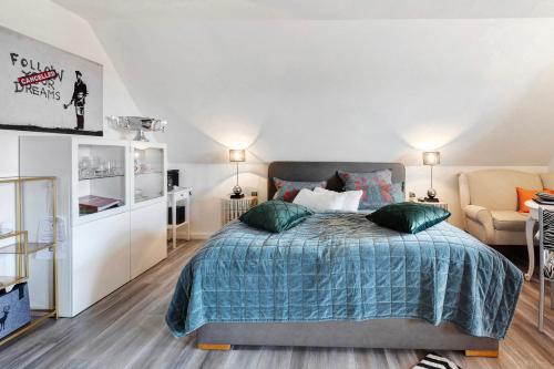a bedroom with a large bed and a chair at Appartement am Kirnbergsee in Bräunlingen