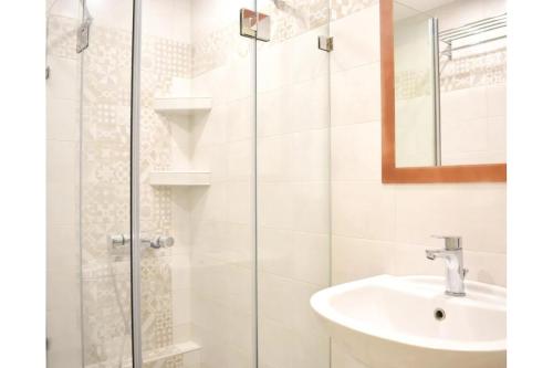 a bathroom with a sink and a glass shower at Manolika Studio 5 in Kithnos
