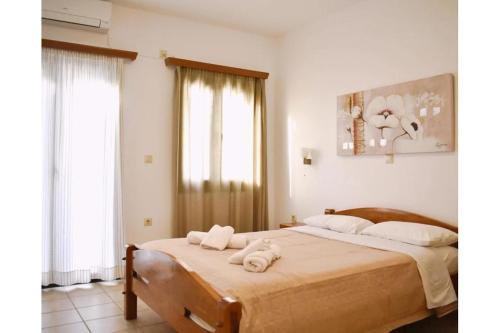 a bedroom with a large bed with towels on it at Manolika Studio 5 in Kithnos