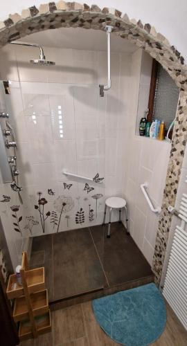 a bathroom with a shower with fish on the wall at Ferienwohnung Wyss - Wolfach in Untertal