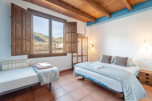 a bedroom with two beds and a window at La Posada in Chera