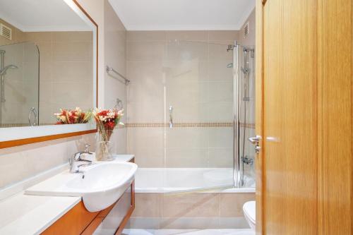 a bathroom with a sink and a toilet and a shower at O'pomar 150 in Tavira