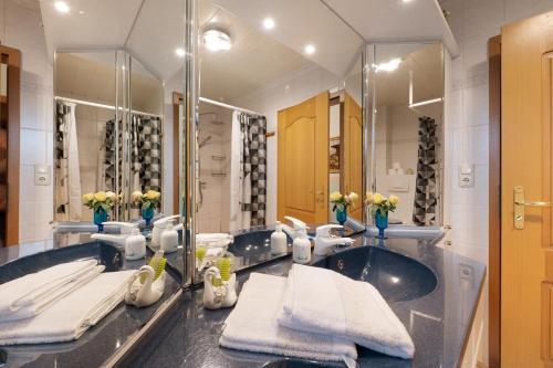 a bathroom with a sink and a large mirror at Fewo Kaiser in Südbrookmerland