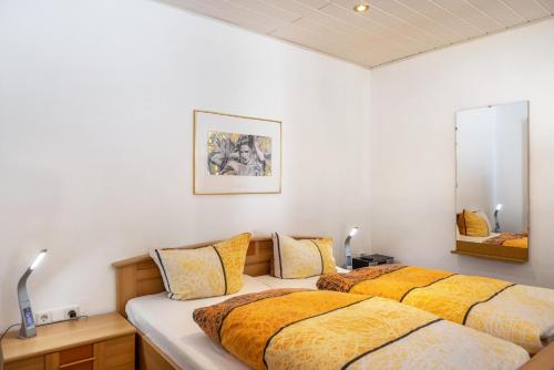 two beds in a room with white walls at Ferienwohnung bei Will in Stützerbach