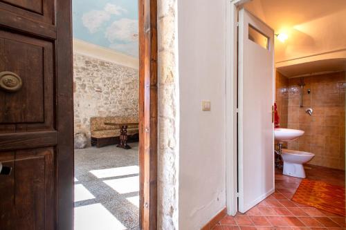 a bathroom with a sink and a toilet in a room at Il Conte e La Contessa in Sennori