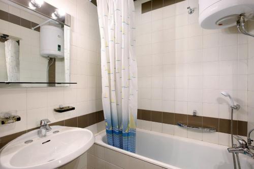 a bathroom with a sink and a bath tub at Appartamenti Larice Pila in Pila