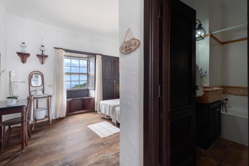 a bedroom with a bed and a table and a window at La Tunera in La Cisnera