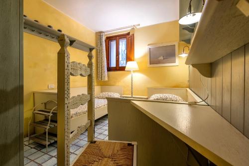 a room with two bunk beds and a staircase at Casa Marina a 150mt dalla pelosa in Stintino
